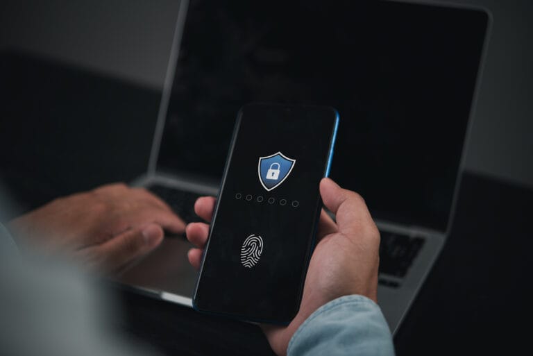 Person using smartphone with fingerprint authentication shown on screen.