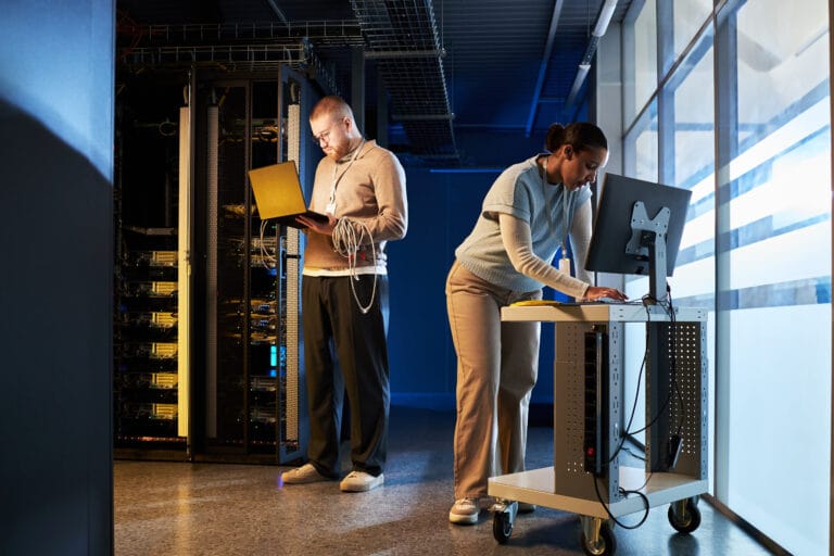 Team engaged in configuring servers in data room.