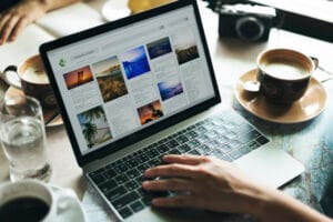 Person uploading content to the CMS with a laptop computer.