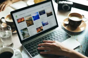 Person uploading content to the CMS with a laptop computer.